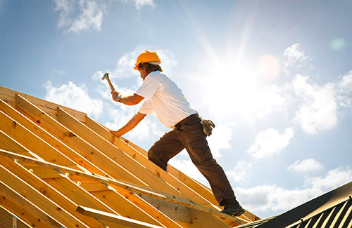 A photo of a roofer in the process of preparing a roof in Calgary for shingle installation.